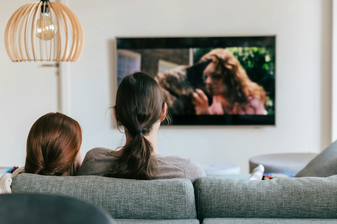 A mother and child sharing an evening watching television